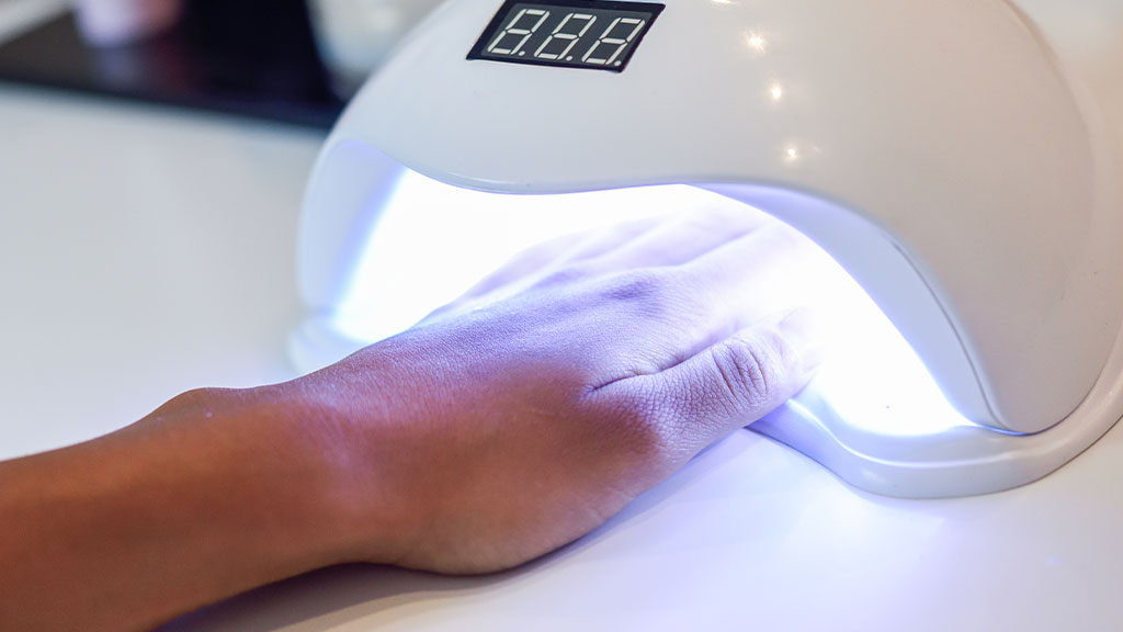 UV LED nail lamp used for curing gel polish during a professional manicure
