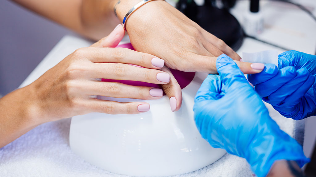 DIY gel manicure at home using a compact UV LED nail lamp