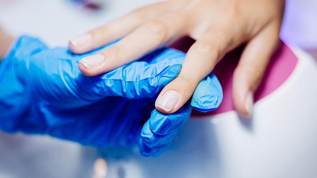 Nail preparation products including nail dehydrator, primer, base coat, and manicure tools arranged before applying gel nail polish.