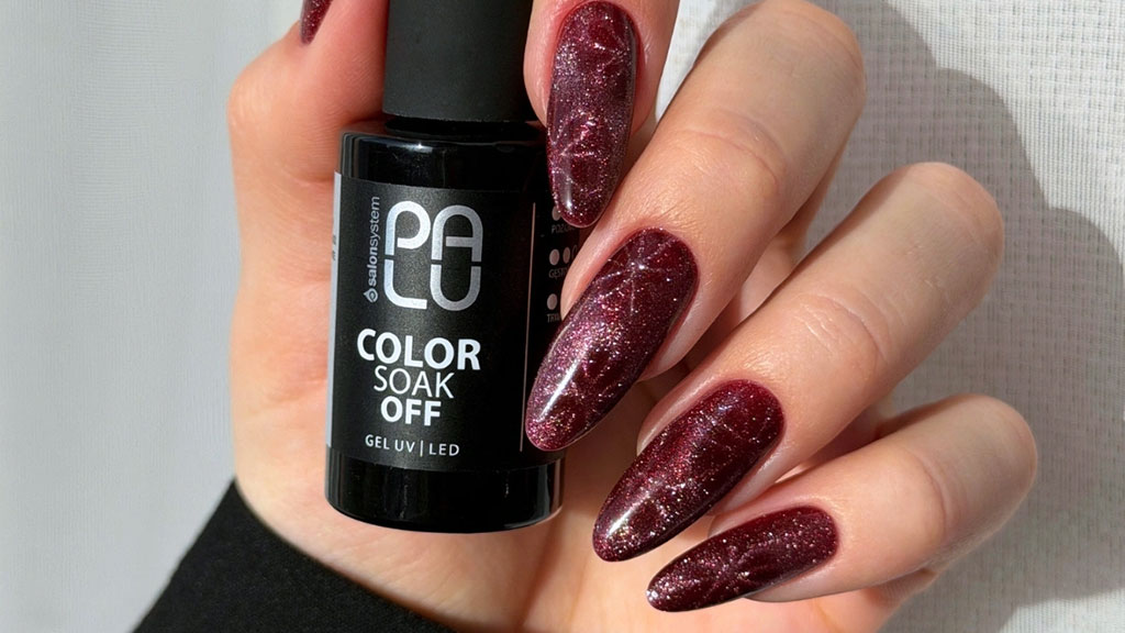 Red cat eye gel polish manicure featuring a shimmering magnetic effect created with Cat Eye Red gel polish.